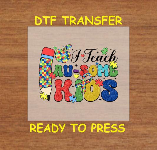DTF transfer that says "I Teach Au-some Kids" with puzzle pieces and pencil.