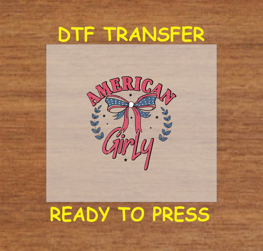 American Girly text with patriotic bow and laurel branches in red, white, and blue.