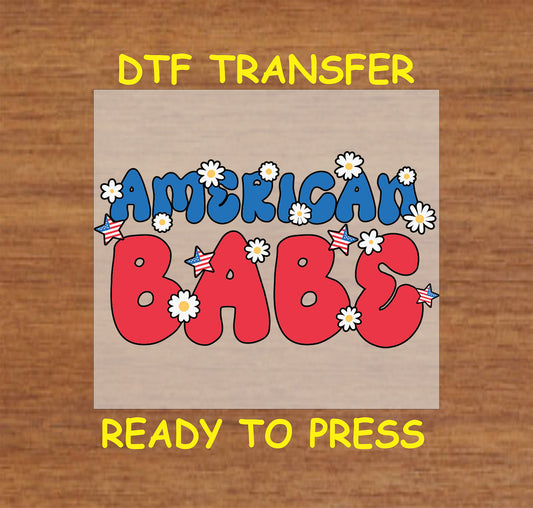 DTF transfer with red and blue American Babe text, stars, and daisies.