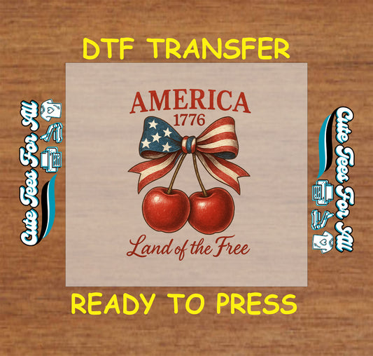DTF transfer with cherries tied in USA flag bow, America 1776, Land of the Free text.