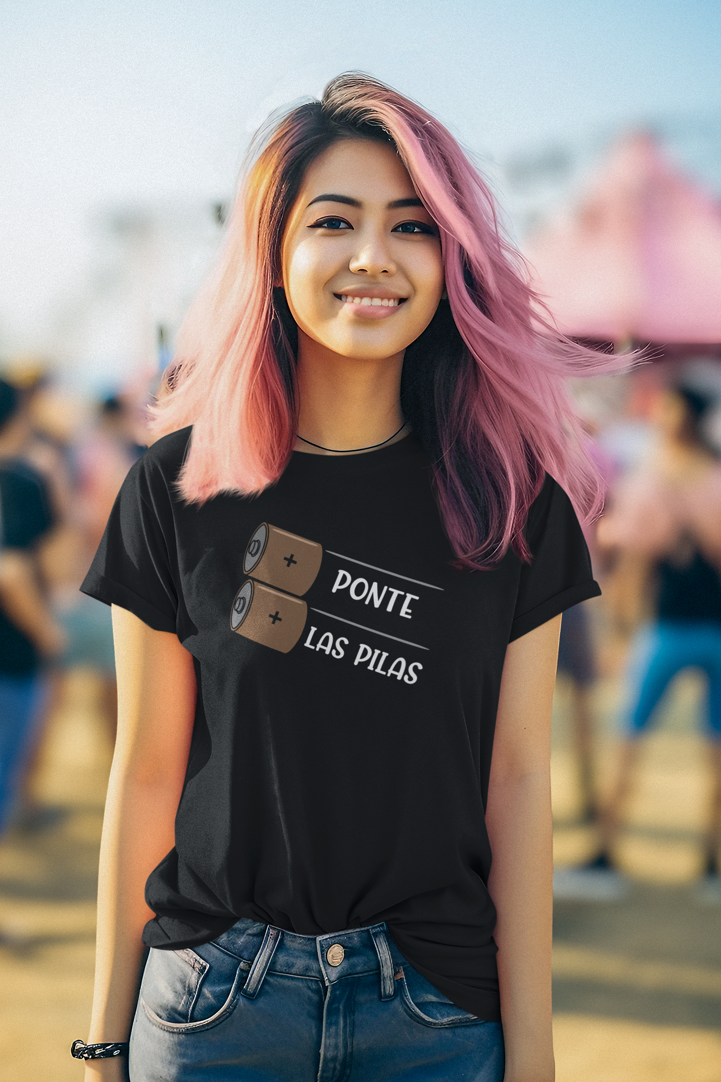 Close-up of a black "Ponte Las Pilas" T-shirt, showcasing the detailed battery design and Spanish motivational phrase.