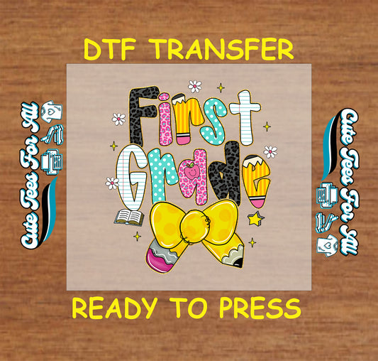 First Grade DTF transfer with colorful letters, yellow bow, pencils, and stars.