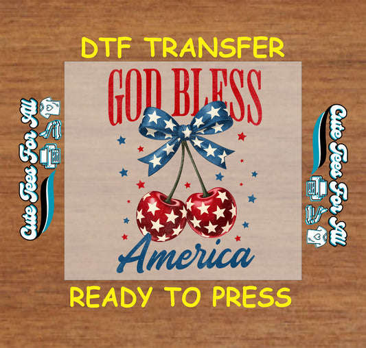 DTF transfer with patriotic cherries, blue star bow, and “God Bless America” text.