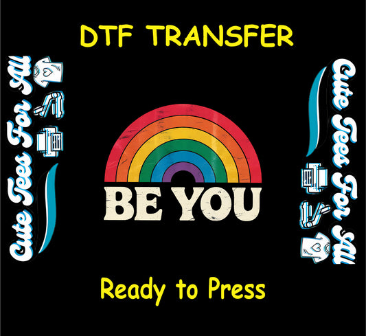 Vintage-style DTF transfer with rainbow arch and bold “Be You” text underneath.