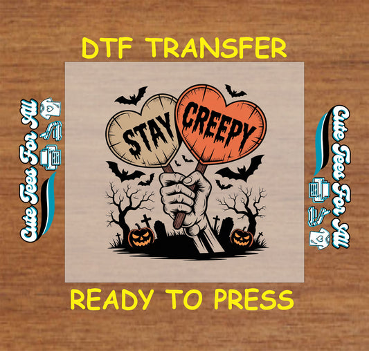 Halloween DTF transfer with skeletal hand holding “Stay Creepy” hearts, pumpkins, bats, and graveyard scene


