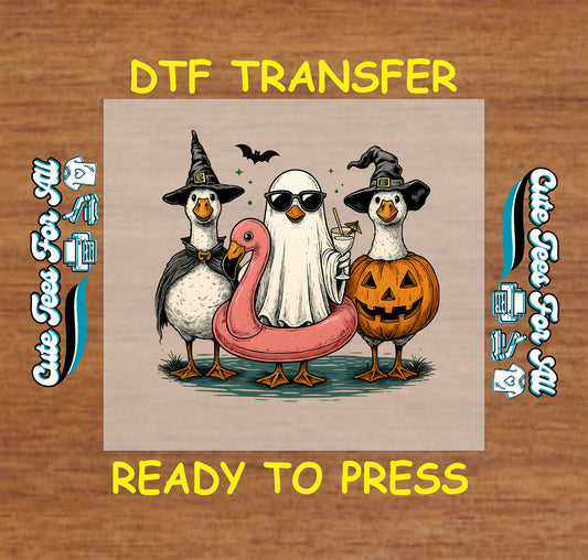 Halloween DTF transfer with ducks in costumes, ghost in flamingo float with drink, witch hat, and jack-o'-lantern

