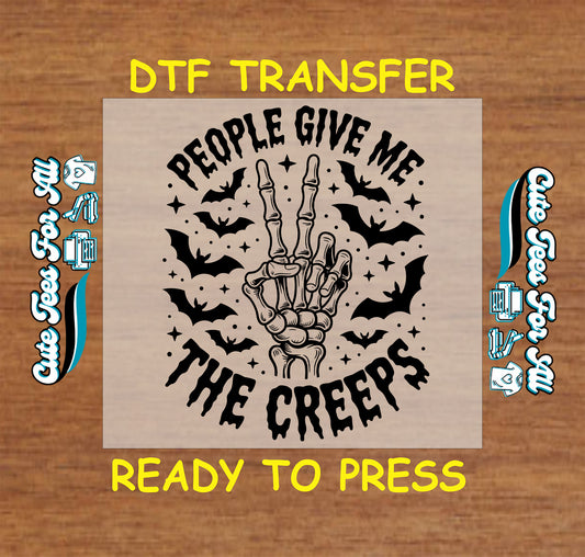 DTF transfer with “People Give Me the Creeps” text, skeleton hand peace sign, bats, and stars

