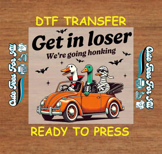 Three Halloween geese in orange car with phrase "Get in loser, we’re going honking"

