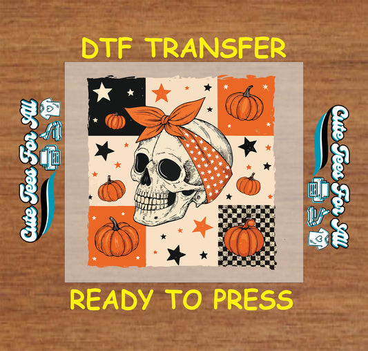 Skull with orange headband in Halloween patchwork with pumpkins, stars, and checkerboard

