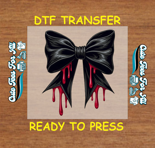 Glossy black bow with realistic red blood dripping from its edges on a Halloween DTF transfer

