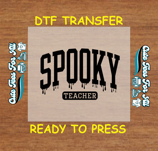ready to press dtf transfer with spooky teacher black text and drip effect on wood tone background

