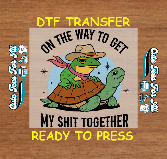 Ready to press dtf transfer of cartoon frog in cowboy hat riding turtle with text on the way to get my sh!t together

