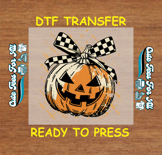 Halloween jack o’lantern with black and white checkerboard bow and splatter effect, ready to press dtf transfer for DIY shirts

