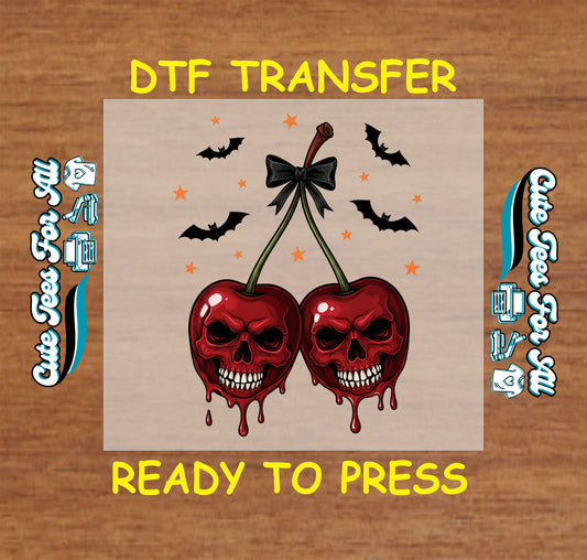 Halloween skull cherries ready to press dtf transfer with red cherry skulls, black bow, bats, and stars for DIY shirts.