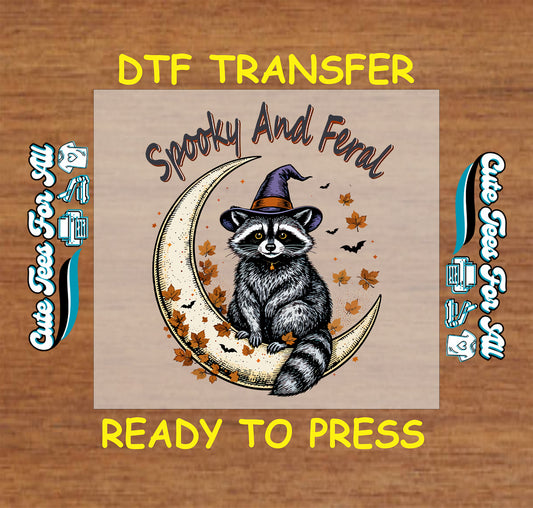 Halloween raccoon dtf transfer spooky and feral on crescent moon with witch hat, leaves, and bats for DIY shirts.