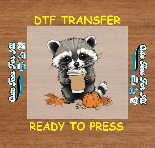 Cute raccoon holding coffee cup with pumpkin and fall leaves ready to press DTF transfer for DIY shirts