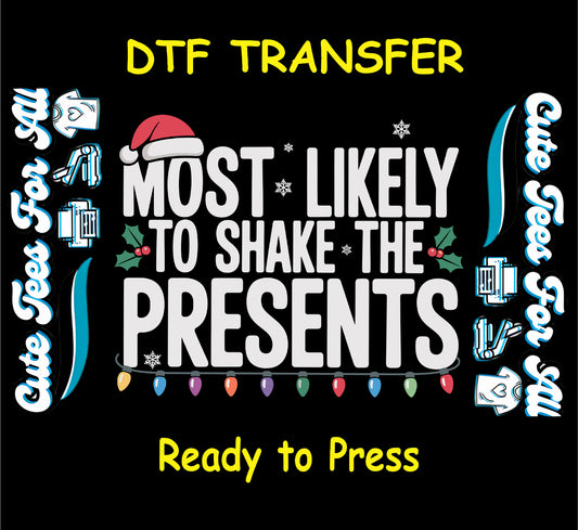 Christmas ready to press dtf transfer with “Most Likely to Shake the Presents” text, Santa hat, holly, snowflakes, and string lights