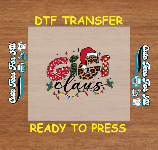 Christmas ready to press DTF transfer with "Gigi Claus" text in holiday patterns, Santa hat, holly, and Christmas lights.