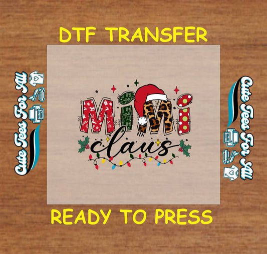 Christmas ready to press DTF transfer with "Mimi Claus" text in festive patterns, Santa hat, holly, and colorful Christmas lights.