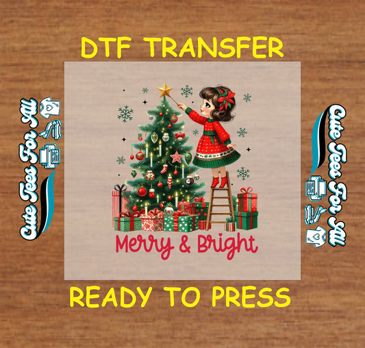 Christmas DTF transfer featuring girl decorating Christmas tree with gifts and text “Merry & Bright,” ready to press iron on heat transfer for DIY shirts.