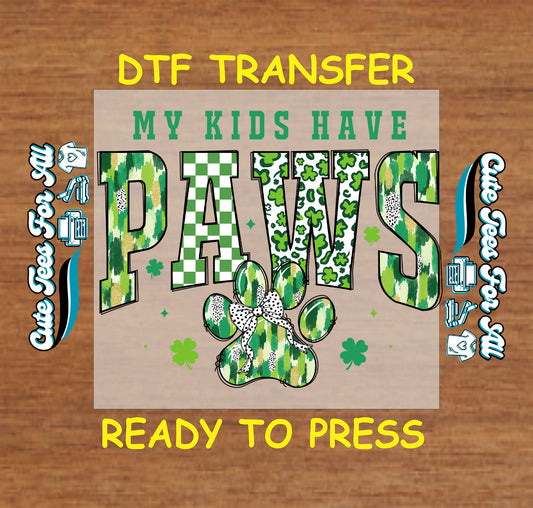 Ready to press dtf St Patricks Day dog paw transfer with my kids have paws text and festive pet themed graphic for DIY shirts