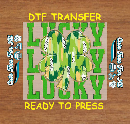 Ready to press dtf St Patricks Day transfer with lucky text and shamrock graphic for DIY shirts