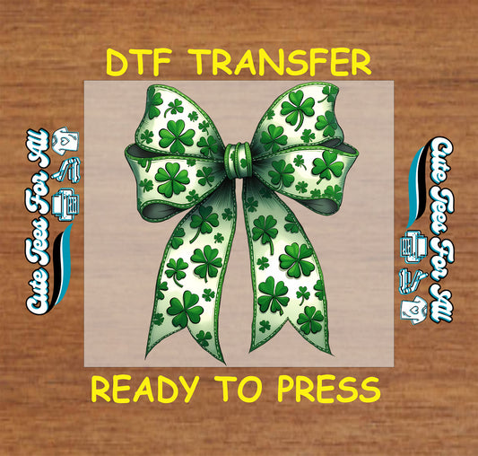 ready to press dtf transfer featuring a shamrock patterned ribbon bow with stitched trim and flowing tails, St Patricks Day themed iron on heat transfer