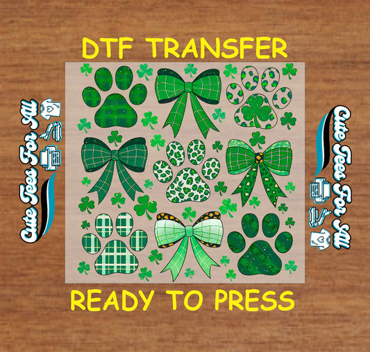 ready to press dtf transfer with paw prints, ribbon bows, and shamrock accents in a St Patricks Day themed pattern for DIY shirts