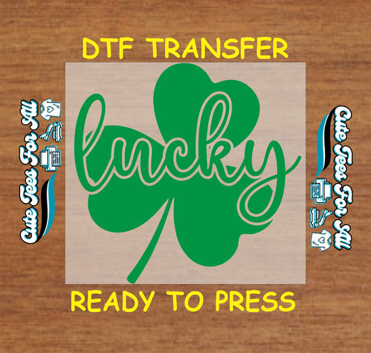 ready to press dtf transfer with lucky script text layered over a shamrock for St Patricks Day DIY shirts