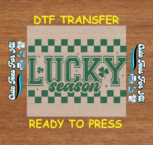 ready to press dtf transfer with lucky season lettering checkerboard pattern and shamrock accents for diy shirts