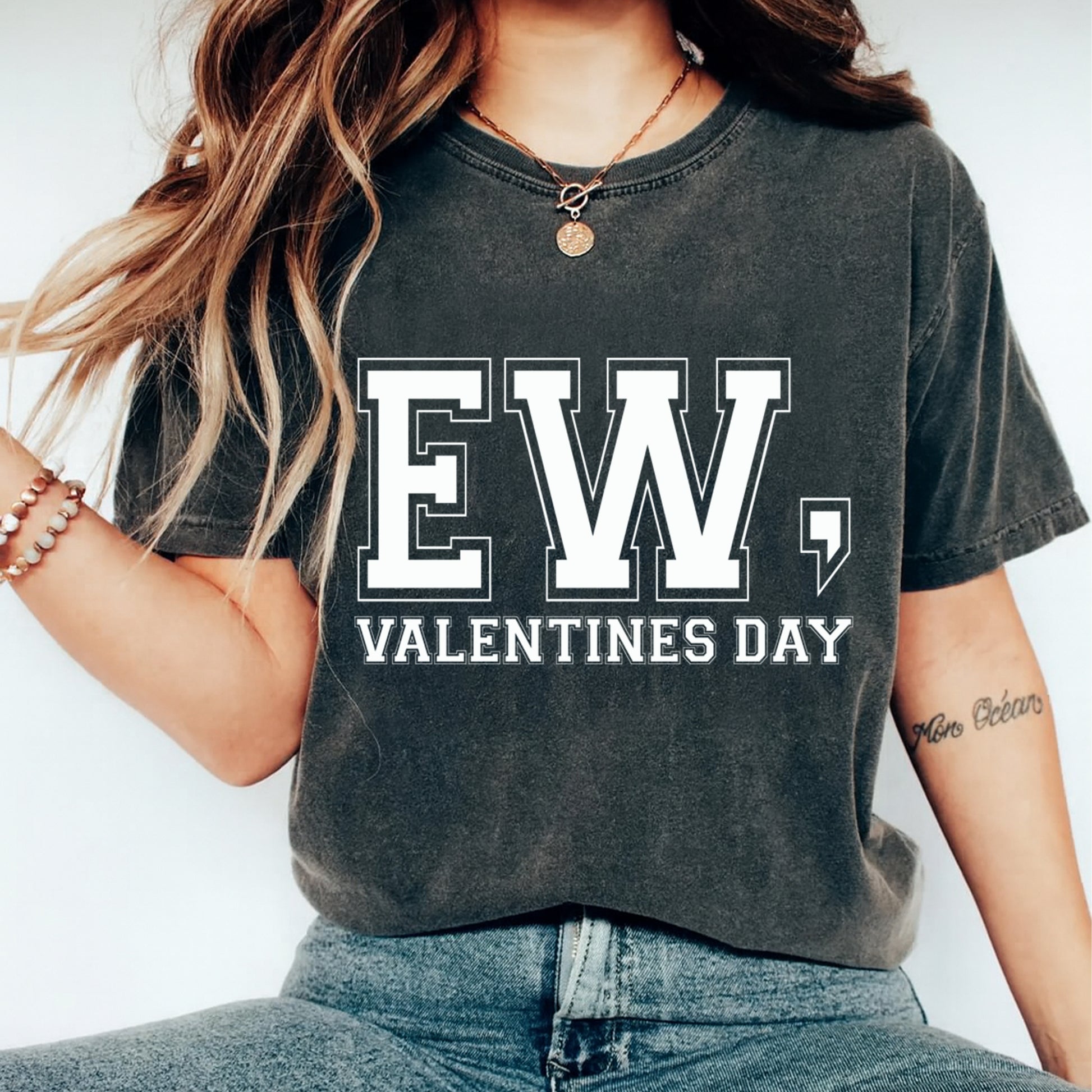 Person wearing a dark gray t-shirt with 'EW, VALENTINES DAY' text on a plain background