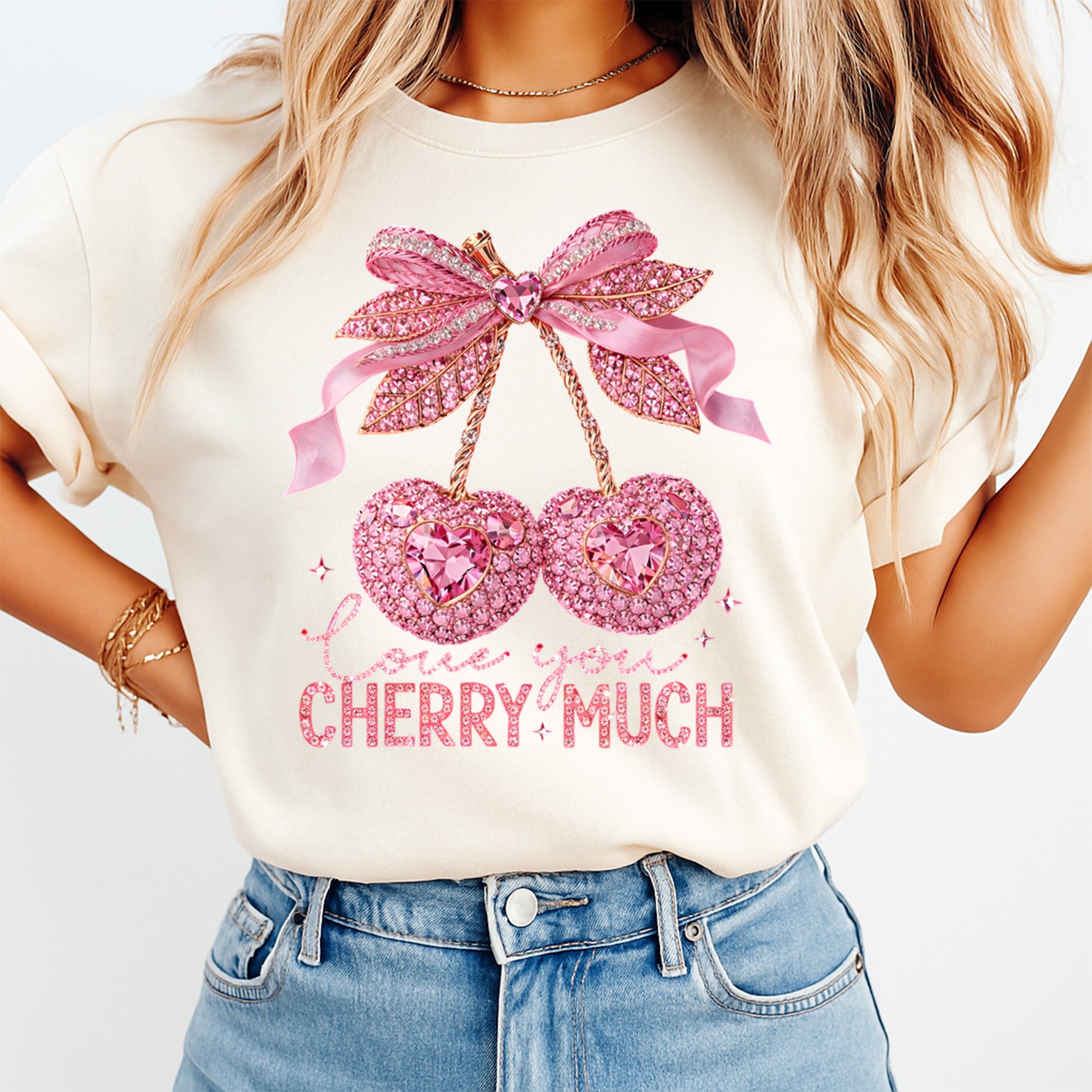 Person wearing a white t-shirt with pink cherry design and text on a plain background