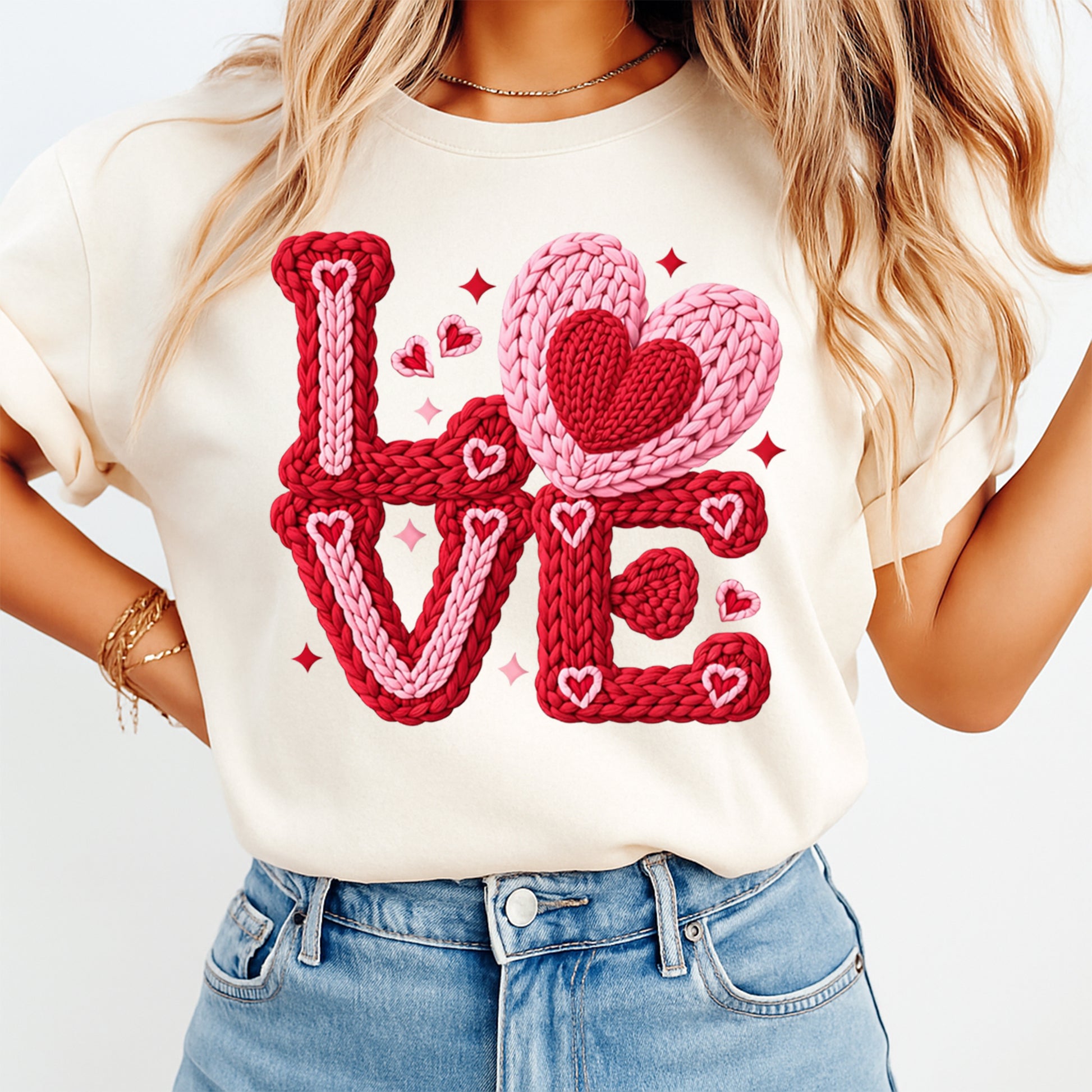 Person wearing a white t-shirt with 'LOVE' in red and pink text on a plain background