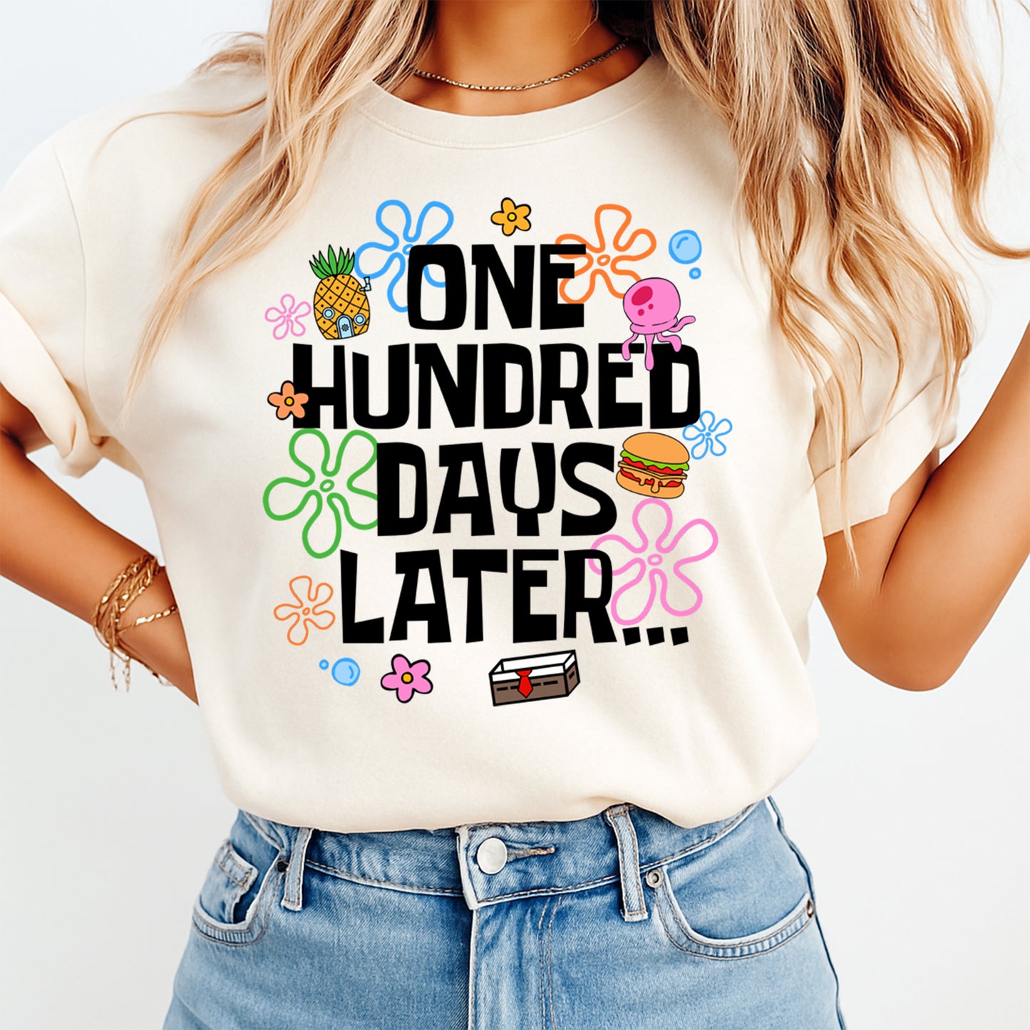 women wearing t shirt with 100 days of school themed lettering with colorful cartoon icons