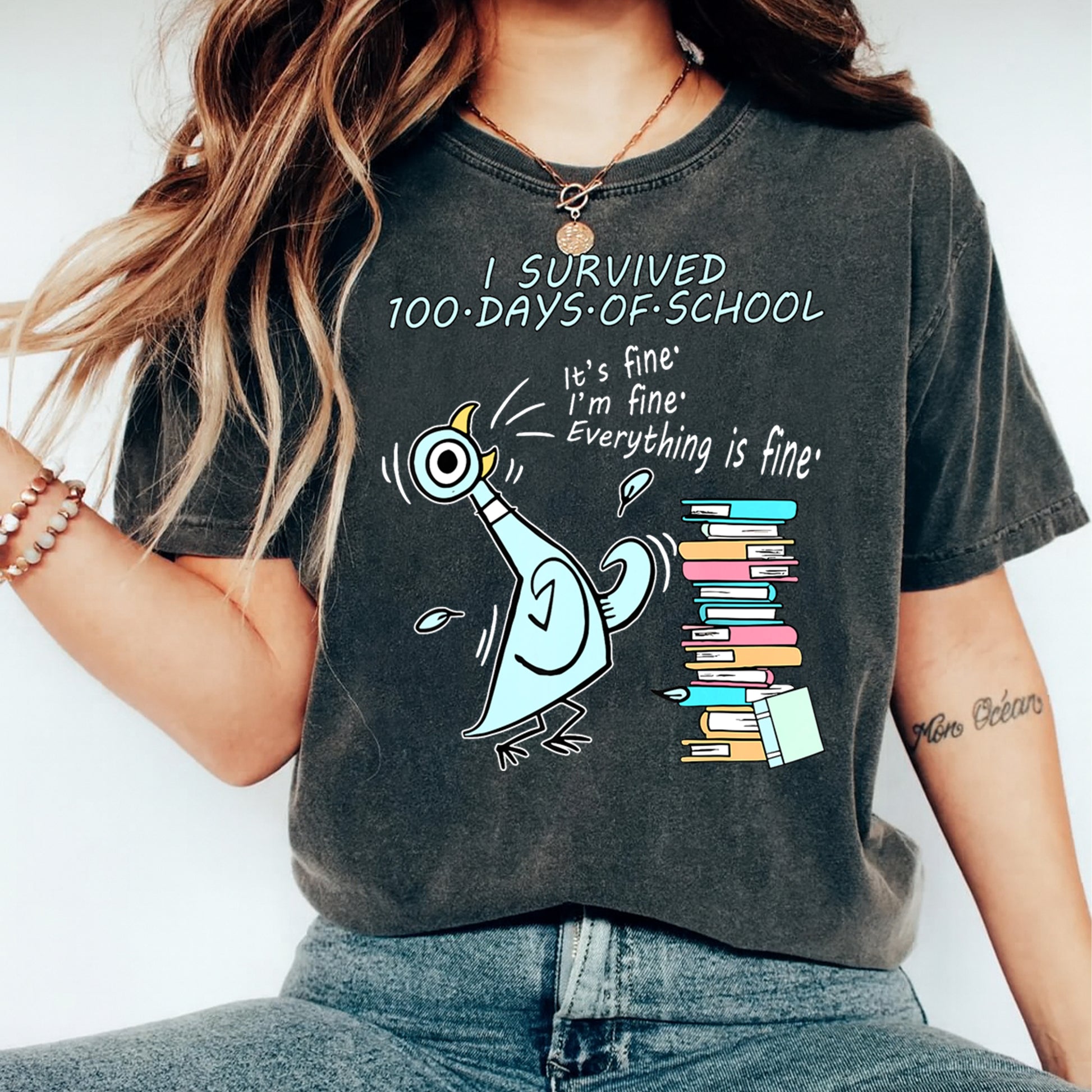 women wearing shirt with I survived 100 days of school cartoon bird with books