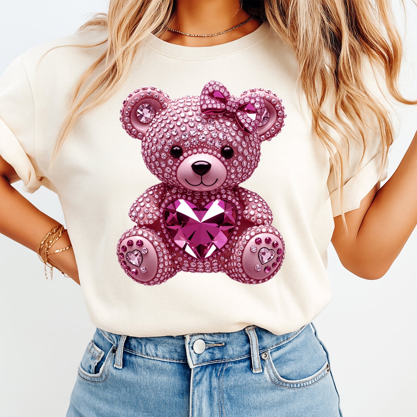 woman wearing cream shirt with pink valentine teddy bear ready to press dtf transfer featuring rhinestone texture heart gemstone and bow detail