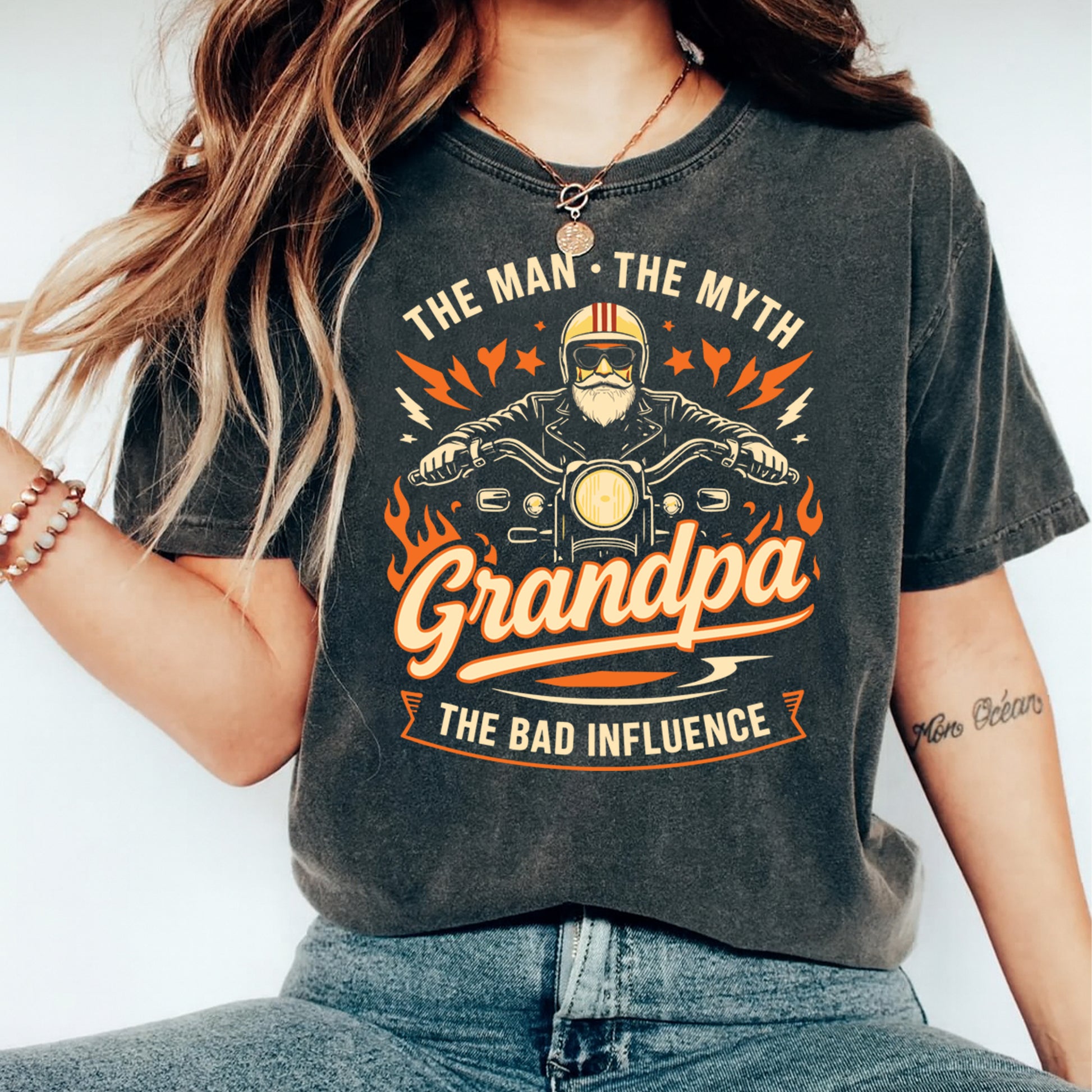 Grandpa the bad influence biker graphic displayed on a dark charcoal t shirt mockup with motorcycle illustration and vintage styling