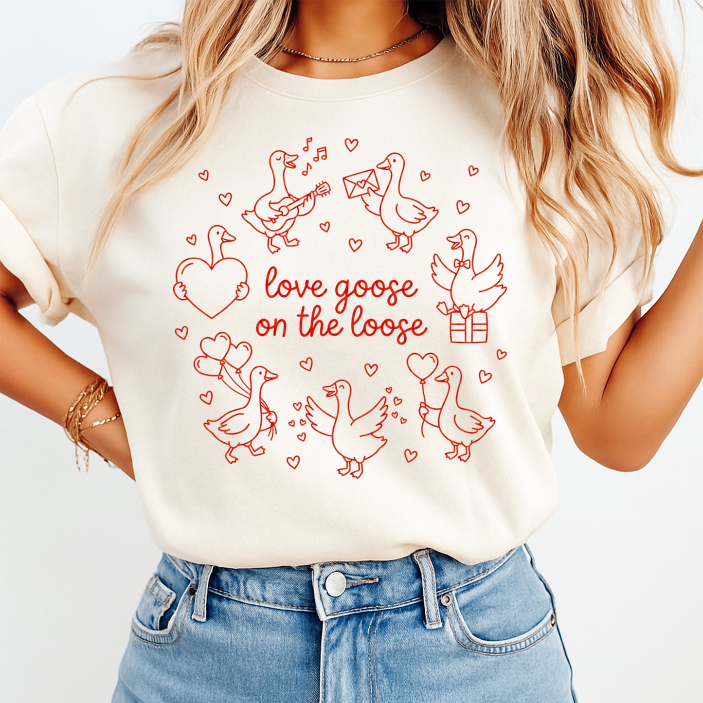 Ready to press dtf Valentine graphic shown on a light color t shirt mockup with red goose illustrations and the text love goose on the loose