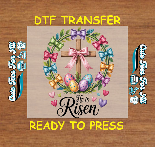 Ready to press dtf transfer artwork featuring he is risen text with cross wreath bows easter eggs and hearts for diy easter shirts.