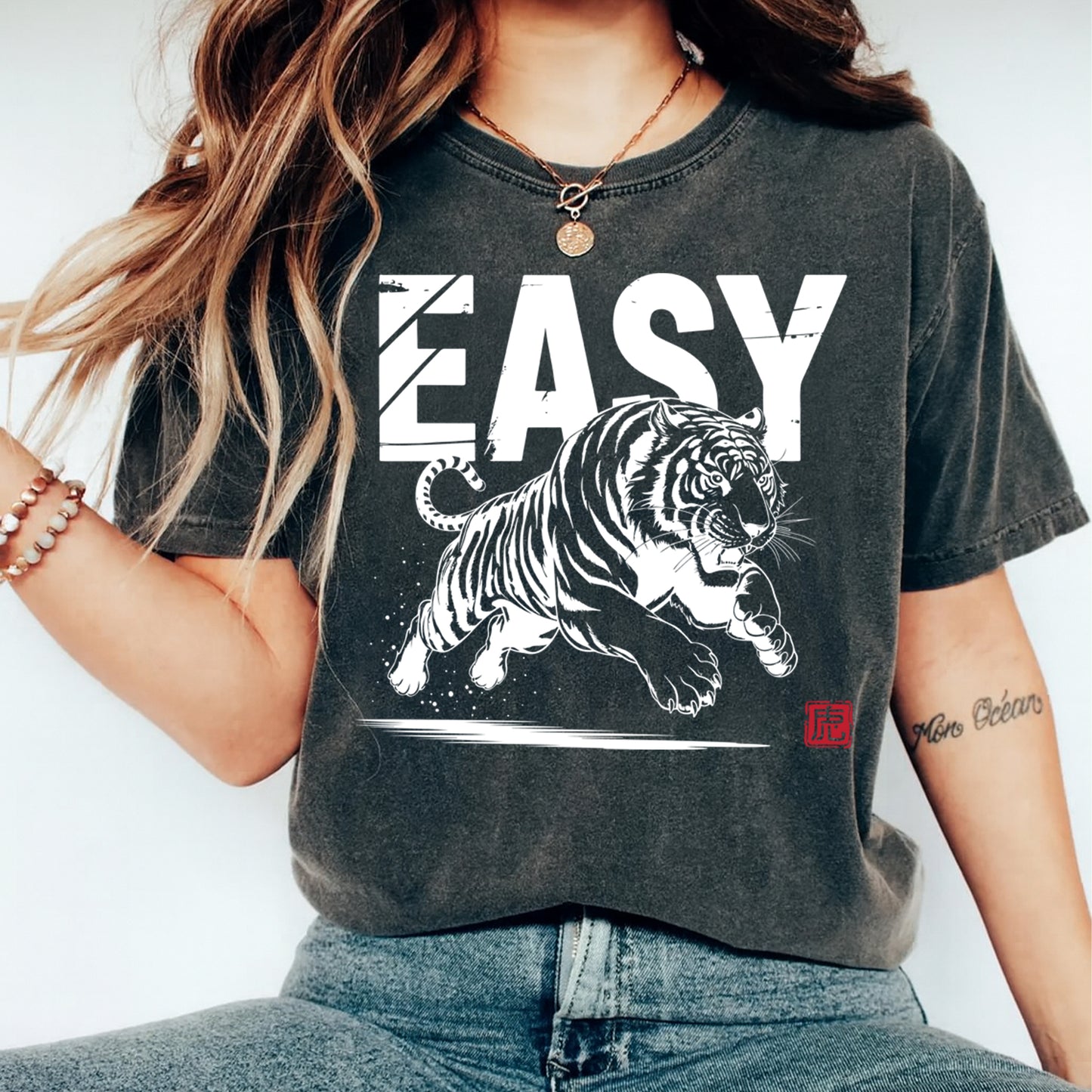 Black t shirt mockup featuring easy text with jumping tiger graphic printed using ready to press dtf transfer