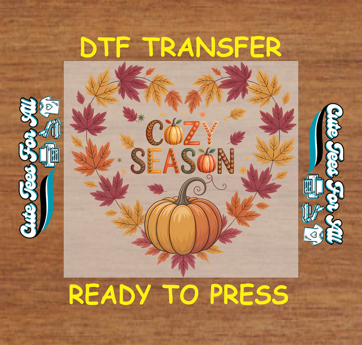 A DTF transfer design preview featuring autumn leaves and a pumpkin arranged around the words 'COZY SEASON' on a beige square, centered on a wood background with yellow text reading 'DTF TRANSFER' and 'READY TO PRESS'.