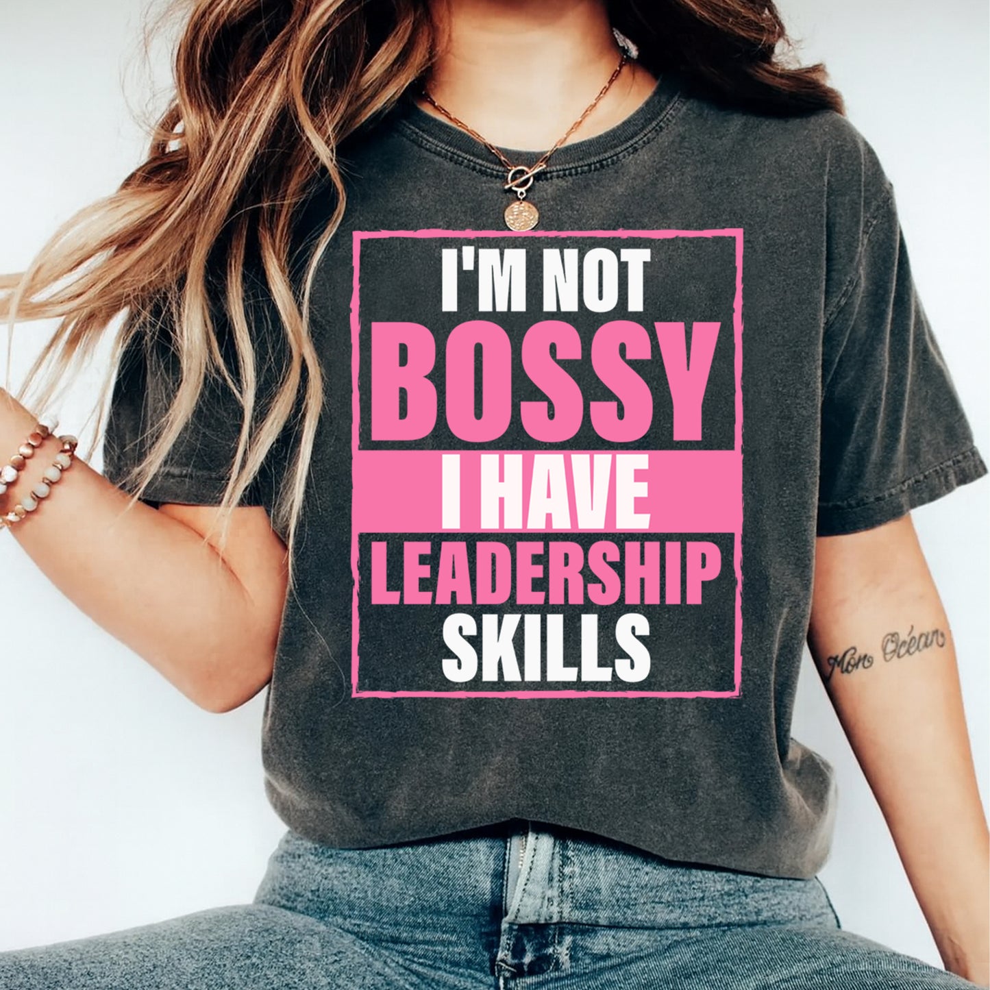 Dark gray t shirt mockup featuring pink leadership quote graphic with boxed text layout