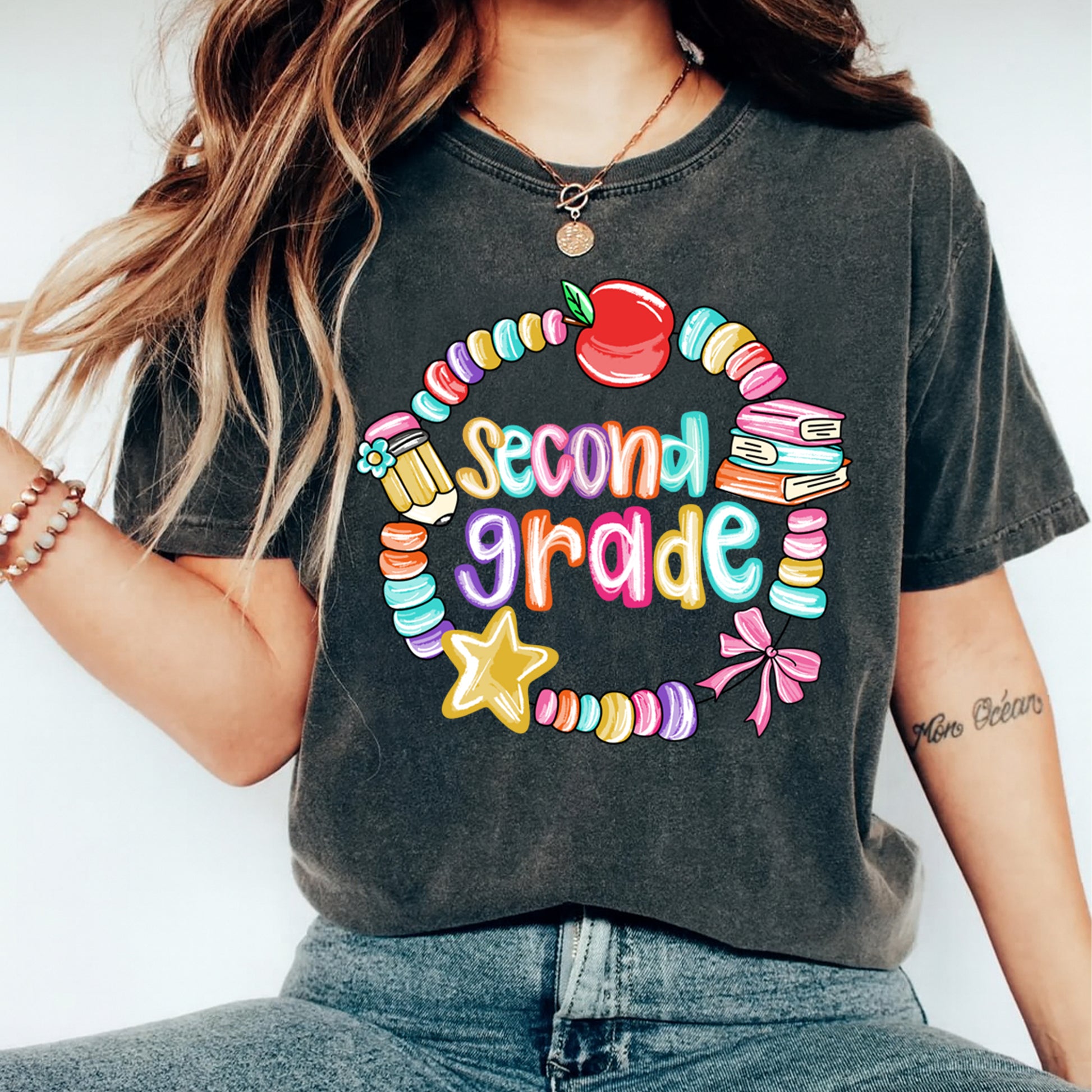 Second grade teacher shirt mockup showing colorful apple and book school graphic pressed on apparel