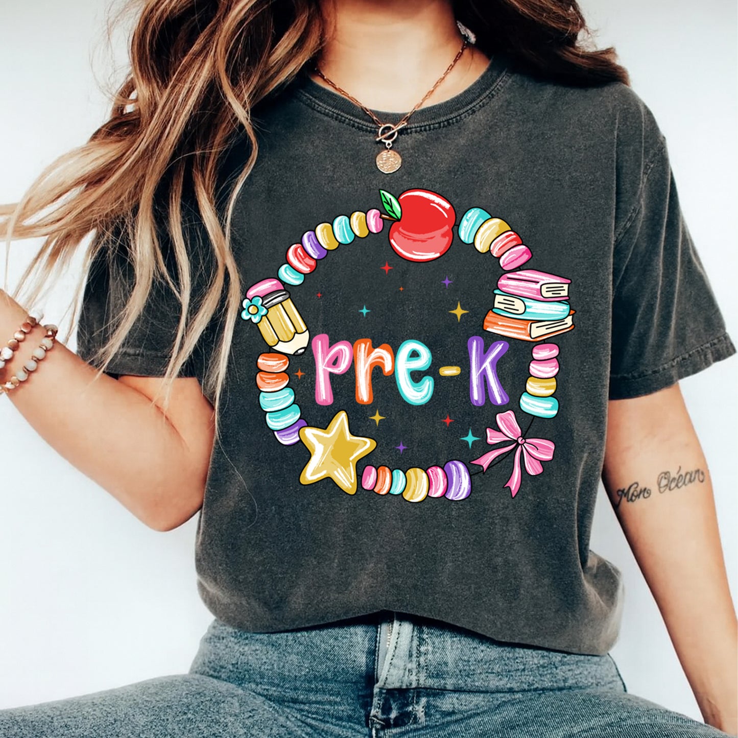 Pre k teacher shirt mockup showing colorful apple and book school graphic pressed on dark gray t shirt
