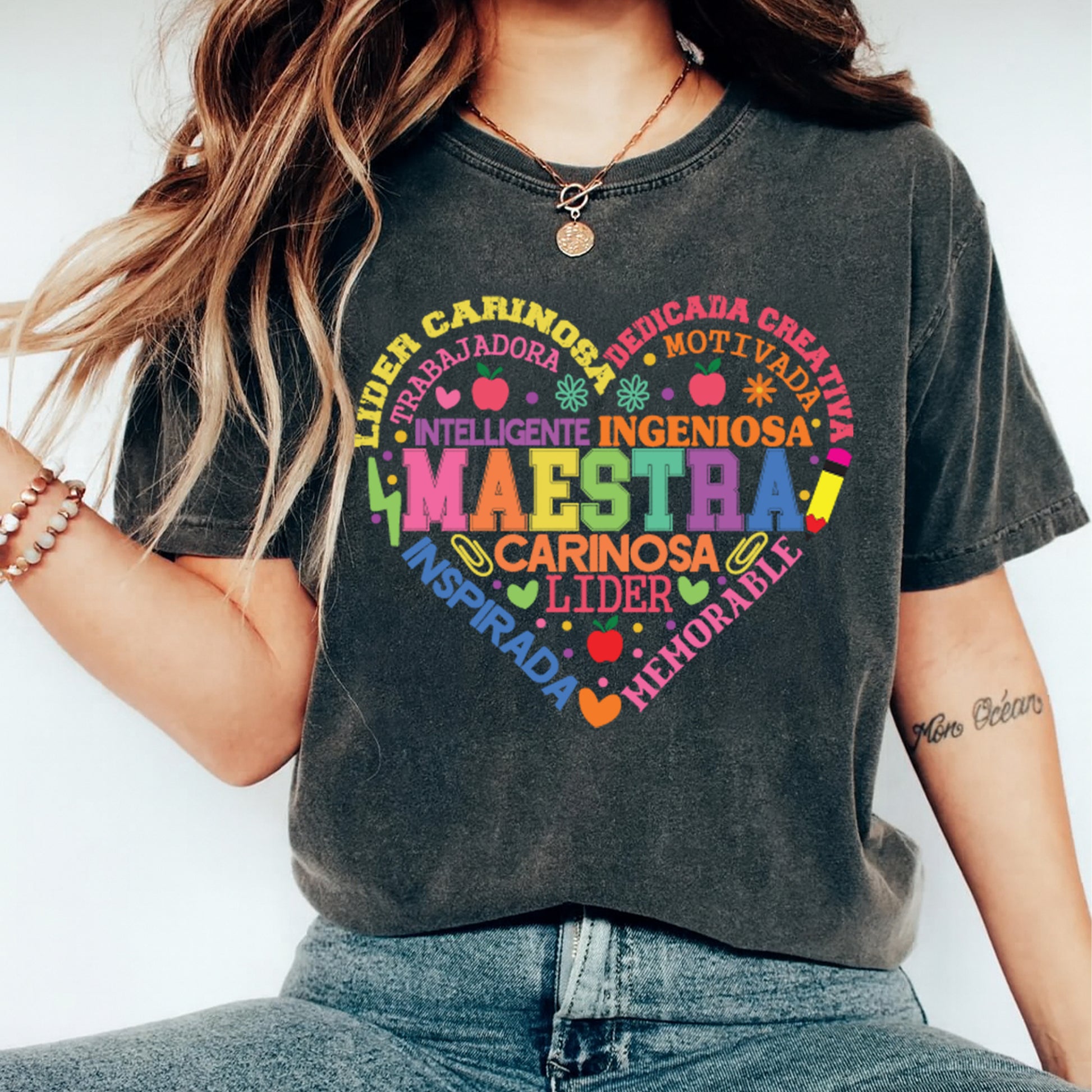 Maestra Spanish heart word art design displayed on dark t shirt mockup with colorful bilingual teacher artwork