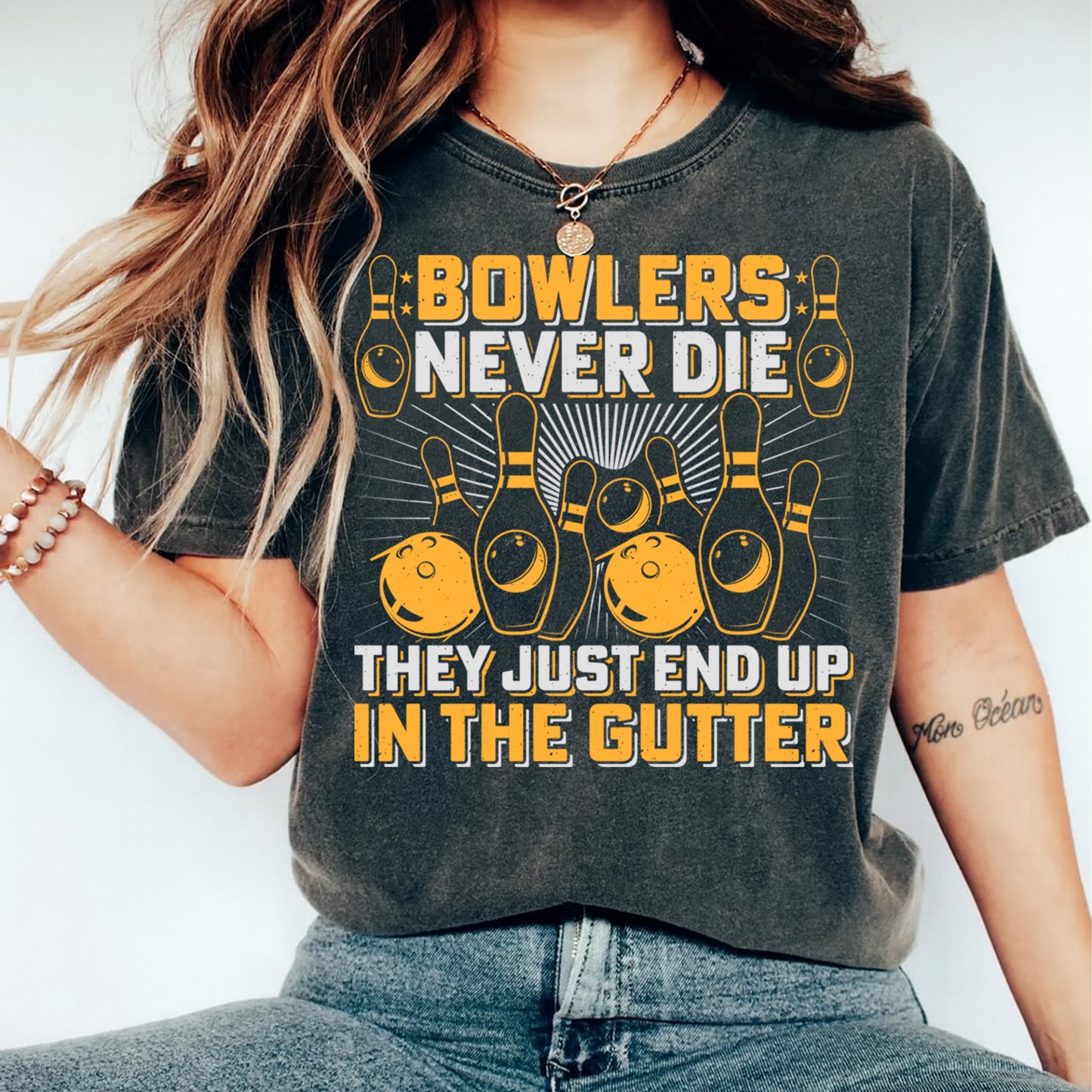 Woman wearing dark gray shirt with bowlers never die bowling graphic ready to press dtf design printed on front
