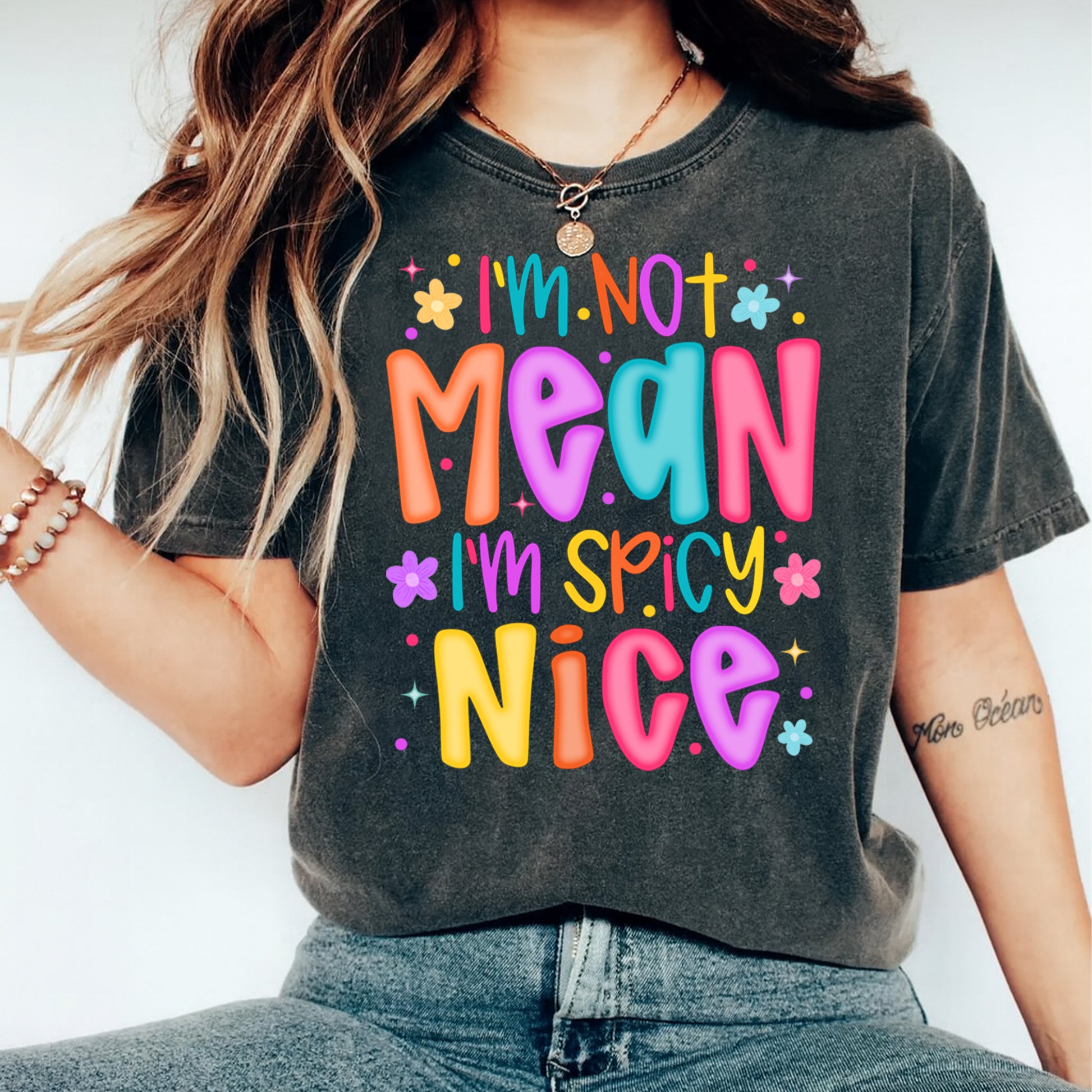 Woman wearing colorful Im not mean Im spicy nice quote shirt with bright playful graphic lettering