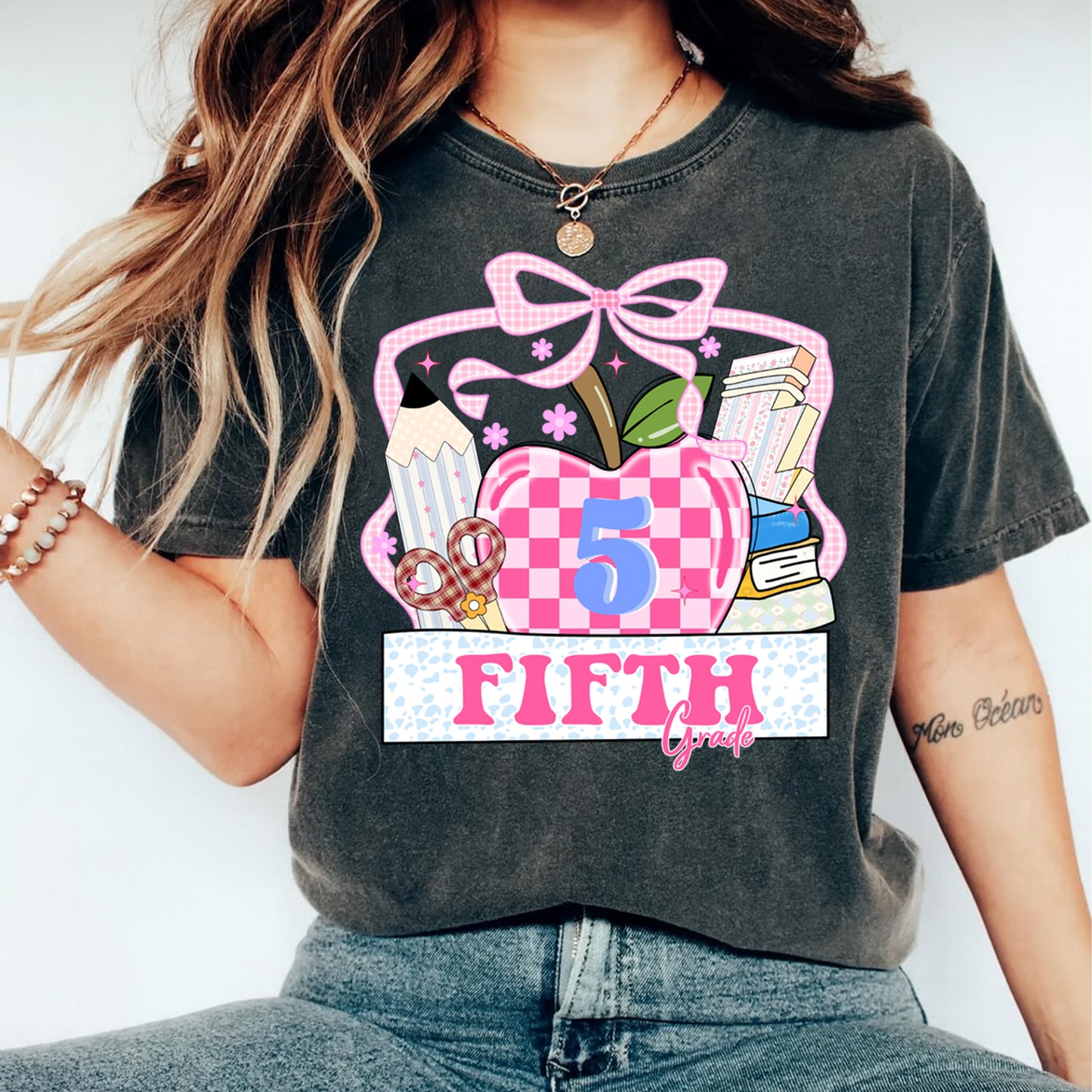 Fifth grade apple graphic printed on shirt mockup featuring pink bow gingham apple and classroom themed artwork