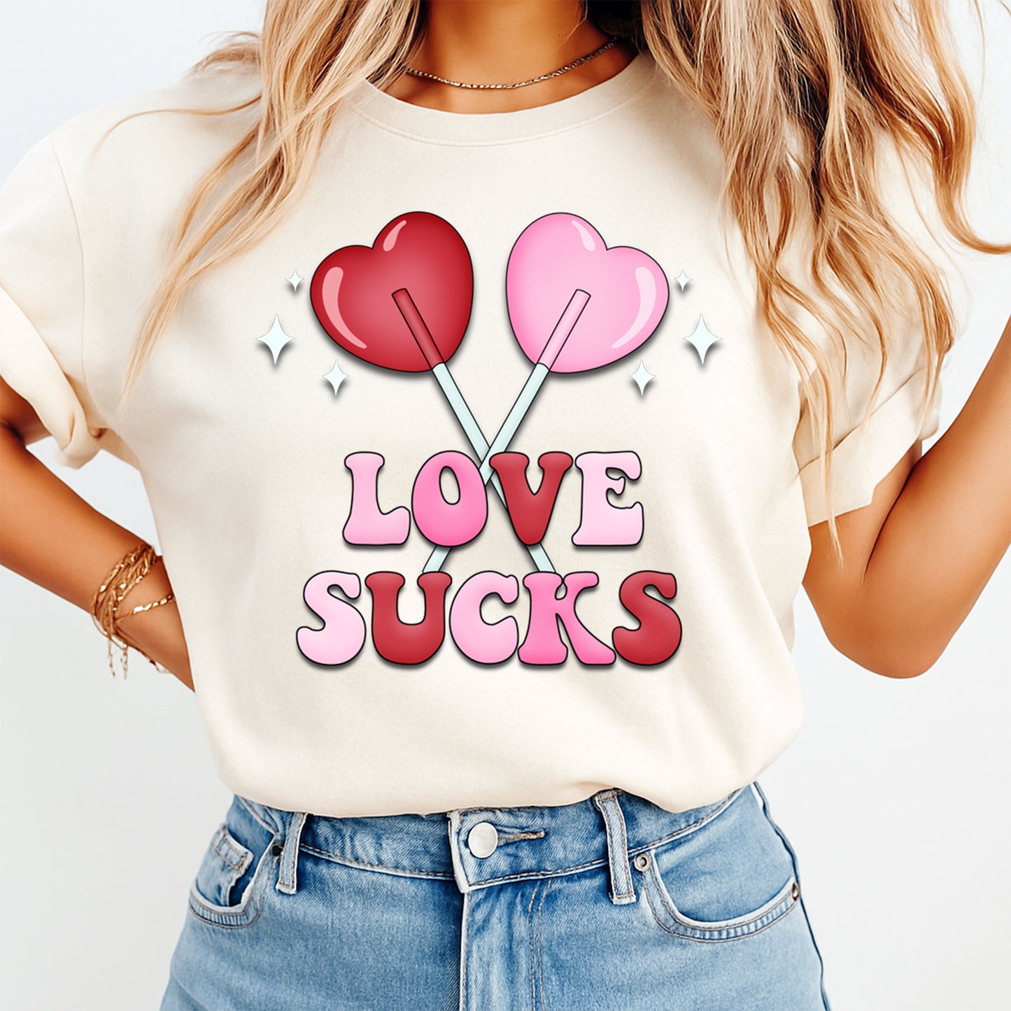 Woman wearing Love Sucks Valentine shirt with pink and red lollipop heart graphic