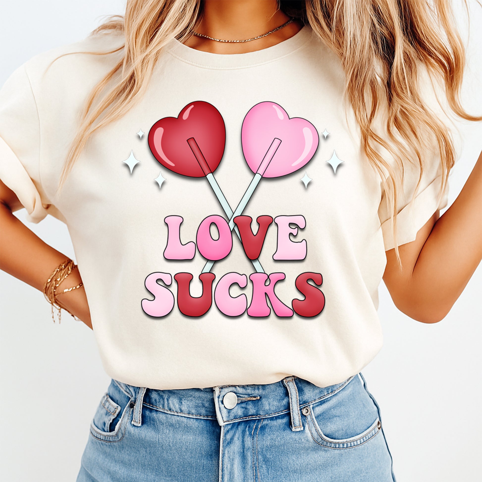 Woman wearing Love Sucks Valentine shirt with pink and red lollipop heart graphic